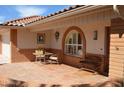 Inviting front patio with brick accents, tile flooring, and cozy seating area for relaxing outdoors at 7906 E Naranja Ave, Mesa, AZ 85209