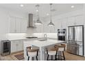 Bright kitchen featuring white cabinets, stainless steel appliances, and a central island with bar stool seating at 8043 E Jaeger St, Mesa, AZ 85207