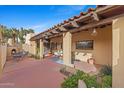 Beautiful outdoor patio with a fireplace, comfortable seating, and views of lush greenery and desert landscape at 8821 N 9Th Ave, Phoenix, AZ 85021