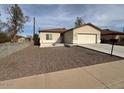 Single story home with a well maintained lawn, a two car garage, and desert landscaping at 9408 W Jackson St, Tolleson, AZ 85353