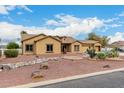 Inviting single-story home with a well-maintained yard, desert landscaping, and a spacious driveway at 9768 W Prospector Dr, Queen Creek, AZ 85144