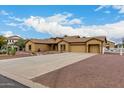 Wide view of a well-kept one-story home with a long driveway and attractive desert landscaping at 9768 W Prospector Dr, Queen Creek, AZ 85144