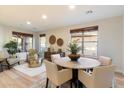 Bright dining room with elegant decor, featuring hardwood floors and natural light creating a cozy atmosphere at 11617 E Raintree Dr, Scottsdale, AZ 85255