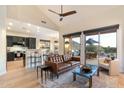 Open-concept living room with a high ceiling, hardwood floors, and seamless access to the outdoor patio at 11617 E Raintree Dr, Scottsdale, AZ 85255