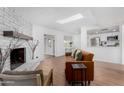 Inviting living room features a painted brick fireplace, skylight, and open layout at 1226 E Fairmont Dr, Tempe, AZ 85282