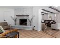 Bright living room features a painted brick fireplace, skylight, and open layout at 1226 E Fairmont Dr, Tempe, AZ 85282