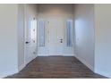Bright foyer with wood flooring and a white door flanked by sidelight windows at 15993 W Poinsettia Dr, Surprise, AZ 85379