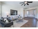 Inviting living room with modern decor, plush seating, and abundant natural light at 15993 W Poinsettia Dr, Surprise, AZ 85379