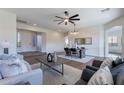 Open-concept living area featuring stylish furnishings, wood floors, and natural lighting at 15993 W Poinsettia Dr, Surprise, AZ 85379