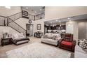 Spacious living room featuring staircase, and open access to kitchen and seating at 17474 W Straight Arrow Ln, Surprise, AZ 85387