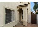 Home's front entrance with security door, columns, and desert landscaping at 1811 S 39Th St # 30, Mesa, AZ 85206