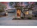 Charming home exterior featuring stone accents, desert landscaping and covered entryway at 21255 W Ashland Ave, Buckeye, AZ 85396