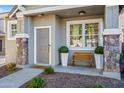 Inviting front porch with stone pillars, bench, and decorative plants at 2315 E Pecan Rd, Phoenix, AZ 85040