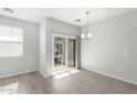 Bright dining area with sliding glass doors to balcony and modern lighting at 2360 E Hidalgo Ave, Phoenix, AZ 85040