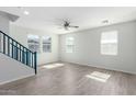 Spacious living room featuring sleek flooring, large windows, and modern ceiling fan at 2360 E Hidalgo Ave, Phoenix, AZ 85040