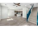 Open-concept living space with modern kitchen, sleek floors, stairs, and ample natural light at 2360 E Hidalgo Ave, Phoenix, AZ 85040