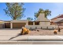 Inviting single-story home with a desert landscape and a two-car garage at 2407 W Paradise Ln, Phoenix, AZ 85023
