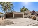 Single-story home with two-car garage and extended driveway at 2407 W Paradise Ln, Phoenix, AZ 85023