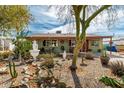 Charming single-story home featuring a well-maintained front yard with mature landscaping at 2925 W Highland Ave, Phoenix, AZ 85017