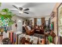 Inviting living room with a ceiling fan, comfortable seating, and ample natural light at 2925 W Highland Ave, Phoenix, AZ 85017