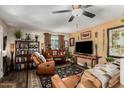 Inviting living room with comfortable leather seating, wooden accents, and neutral colors at 2925 W Highland Ave, Phoenix, AZ 85017