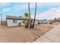 Charming single-story home featuring desert landscaping and well-maintained sidewalks at 3217 E Friess Dr, Phoenix, AZ 85032