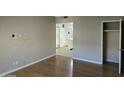 Empty living room with hardwood floors, neutral paint and a view of a bathroom and kitchen at 349 E Thomas Rd # E402, Phoenix, AZ 85012