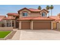 This property features a spacious three-car garage and desert-style landscaping at 4129 E Nighthawk Way, Phoenix, AZ 85048