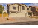 Inviting two-story home featuring a three-car garage and neutral stucco exterior at 43646 W Elizabeth Ave, Maricopa, AZ 85138