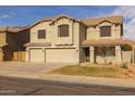 Inviting two-story home featuring a three-car garage and neutral stucco exterior at 43646 W Elizabeth Ave, Maricopa, AZ 85138