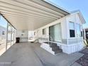 Welcoming mobile home showcasing a covered carport providing lots of space at 455 S Jaspar Dr, Apache Junction, AZ 85119