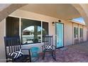 Inviting front porch with cozy rocking chairs and a stylish welcome mat, complete with turquoise colored door at 4713 W Kelton Ln, Glendale, AZ 85306