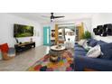 Bright living room featuring modern furnishings, colorful rug, and stylish decor with turquoise accent door at 4713 W Kelton Ln, Glendale, AZ 85306