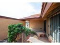 Private courtyard featuring desert landscaping, decorative stone, wrought iron gate, and access to the home at 4916 E Hopi St, Phoenix, AZ 85044