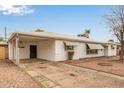 View of single story home with covered parking, neutral desert landscaping and awnings on the windows at 5525 N 21St Ave, Phoenix, AZ 85015