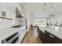 Modern kitchen with a view into the breakfast nook and great room area at 5650 S Feliz --, Mesa, AZ 85212