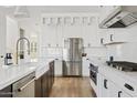 Updated kitchen featuring stainless steel appliances, white cabinets, and a stylish backsplash at 5650 S Feliz --, Mesa, AZ 85212