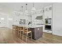 Spacious kitchen with a large island, modern appliances, and white cabinetry at 5650 S Feliz --, Mesa, AZ 85212