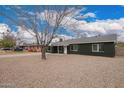 A single-story home showing the long side with desert landscaping, complemented by the well-kept street at 6119 N 18Th Dr, Phoenix, AZ 85015