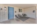 Welcoming front porch with stylish seating and a charming blue front door at 6943 E Granada Rd, Scottsdale, AZ 85257