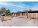 Cozy one-story home with a long driveway, fenced-in area, and a simple yet inviting facade at 7017 W Beatrice St, Phoenix, AZ 85043