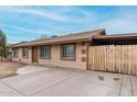 Charming single-level home with an extended driveway and fenced yard, blending functionality with curb appeal at 7017 W Beatrice St, Phoenix, AZ 85043