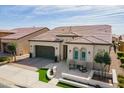 Beautiful exterior features desert landscaping, covered entry, and a two-car garage with a paved driveway in a sunny neighborhood at 825 E Farmers Ln, Queen Creek, AZ 85140