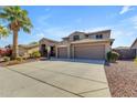 Attractive two-story home with a three-car garage, a wide driveway, and easy-care desert landscaping at 8761 W Mary Ann Dr, Peoria, AZ 85382