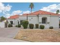 Warm home exterior showcases a well-manicured yard and classic architectural details at 9155 N 107Th St, Scottsdale, AZ 85258