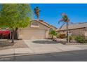 Charming home featuring a two-car garage, desert landscaping, and neutral color palette at 9922 E Onza Ave, Mesa, AZ 85212