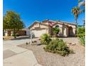 Inviting single-story home featuring well-maintained desert landscaping and a welcoming entrance at 9922 E Onza Ave, Mesa, AZ 85212