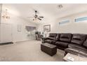 Spacious living room featuring a ceiling fan and comfortable leather seating at 1297 E Maddison St, San Tan Valley, AZ 85140