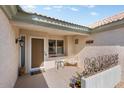 Inviting front porch features a cozy bench, neutral colors, and a welcoming entrance at 14108 W Circle Ridge Dr, Sun City West, AZ 85375