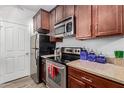 Well-equipped kitchen with stainless steel appliances, dark wood cabinetry, and granite countertops at 14145 N 92Nd St # 1031, Scottsdale, AZ 85260
